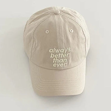Beige cap with 'always better than ever' text on a light gray background