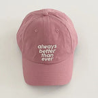 Pink cap with 'always better than ever' text on a light gray background