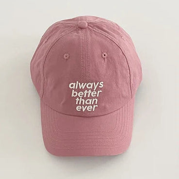 Pink cap with 'always better than ever' text on a light gray background