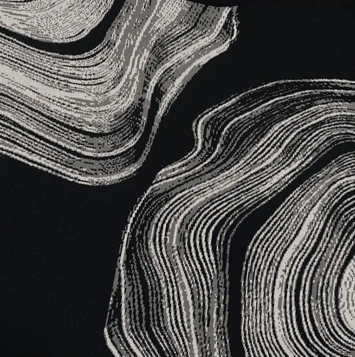 Black and white abstract pattern on sweater.