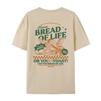 Tan t-shirt with Bread Of LIfe -themed graphic and text on a white background