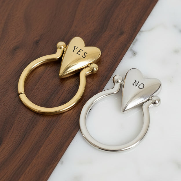 Gold and silver heart-shaped keychains with 'NO' and 'YES'.
