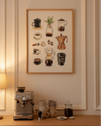A framed coffee-themed art print hangs on a beige wall above a wooden counter with a coffee machine, stacked mugs, and coffee accessories in a warm, styled kitchen or cafe setting.
