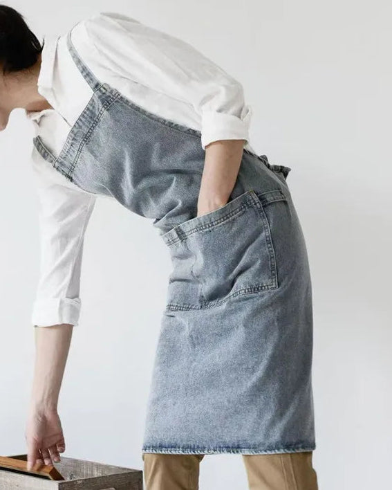Person wearing a Draper Denim Apron over a white shirt on a plain background
