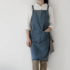 Person wearing a Draper Denim Apron over a white shirt against a plain background