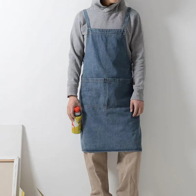 Person wearing a Draper Denim Apron holding a spray bottle against a plain background