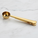 Gold measuring spoon on a marble surface