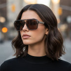Woman wearing sunglasses with a blurred city street background