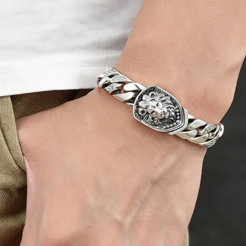 Silver bracelet on a wrist with a neutral background