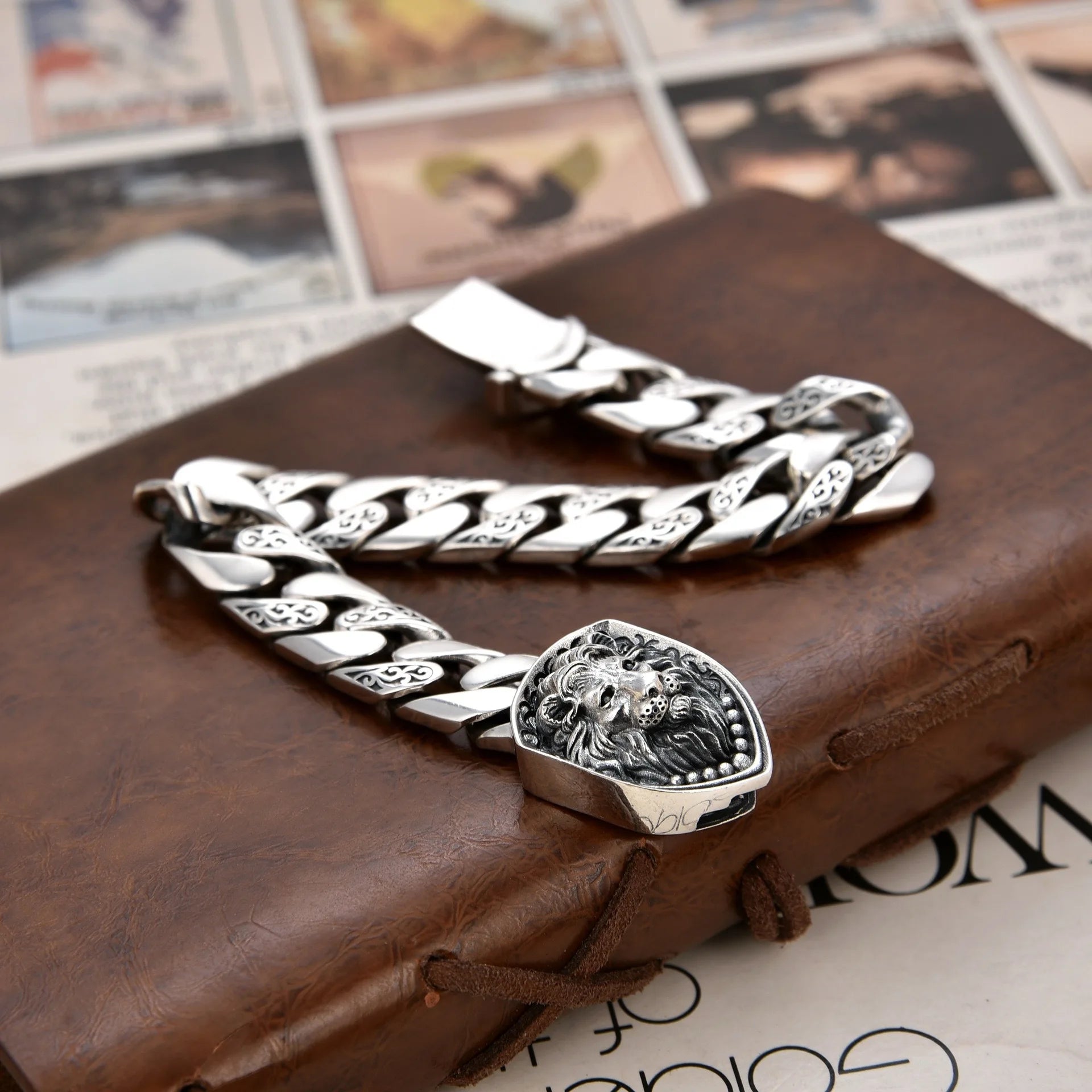 Silver chain bracelet with a detailed clasp on a textured surface