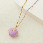 Necklace with a purple heart-shaped pendant on a neutral background