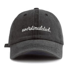 Black cap with 'overstimulated' text on a white background