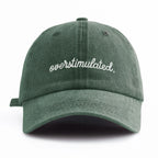 Green cap with 'overstimulated' text on a white background