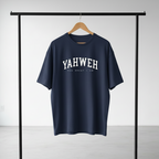 Navy blue t-shirt with 'YAHWEH' printed on it, hanging on a rack against a plain background.