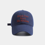 Blue cap with red text 'Break Free From The Routine' on a white background.