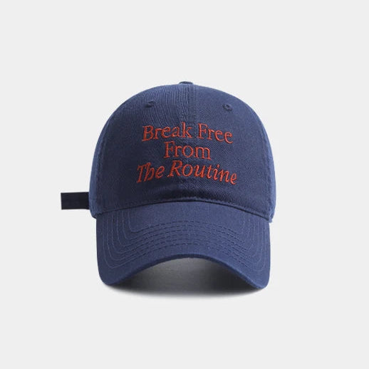 Blue cap with red text 'Break Free From The Routine' on a white background.