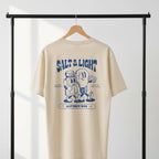 Beige Christian t-shirt with blue "Salt and Light" graphic design and text on a hanger against a white background.