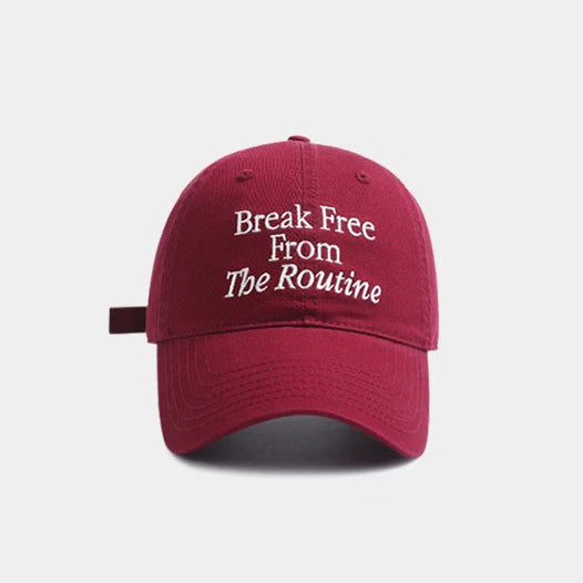 Red cap with 'Break Free From The Routine' text on a white background.