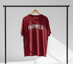 Maroon t-shirt with 'YAHWEH' text on a black rack against a gray background