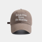 Taupe cap with 'Break Free From The Routine' text on a white background.