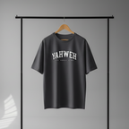 Gray t-shirt with 'YAHWEH' text on a hanger in a white studio.