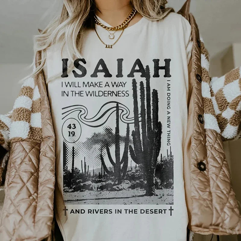 Person wearing a white t-shirt with 'ISAIAH' text and cactus design, paired with a beige quilted jacket.