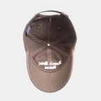 Brown cap with white text on a light gray background.