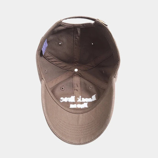 Brown cap with white text on a light gray background.