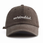 Brown cap with 'overstimulated' text on a white background