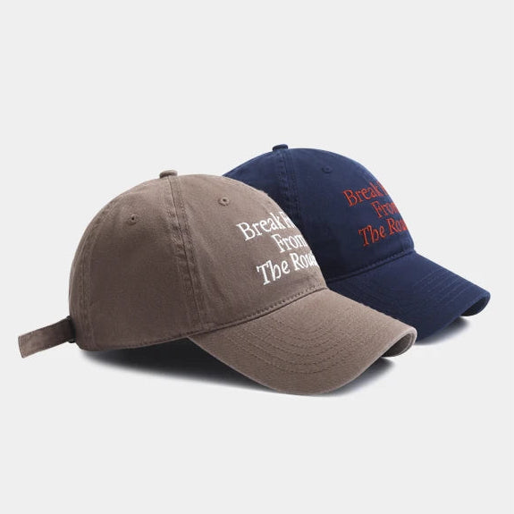 Two baseball caps, one brown and one navy, with text on a light gray background.