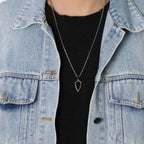 Model wearing the Steadfast Shield necklace with a black tshirt and light denim jacket.