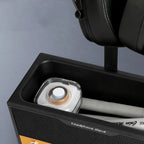 Close-up of a headphone stand holding a pair of headphones with a blurred background