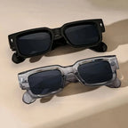 Two pairs of sunglasses on a beige background