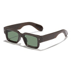 Brown sunglasses with green lenses on a white background