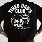 Black long-sleeve shirt with 'Tired Dad's Club' design featuring a skull and coffee cup on a white background.